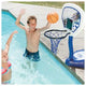 Children playing basketball in a pool with a pool-side hoop