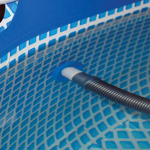 Close-up of a pool vacuum head on a blue pool surface
