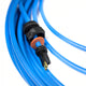 Coiled blue cable with connectors on a white background