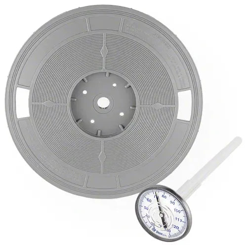 Gray spool of thread with a dial thermometer on a white background