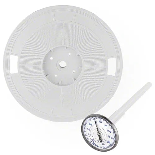 White temperature gauge with a large spool of white tape on a white background