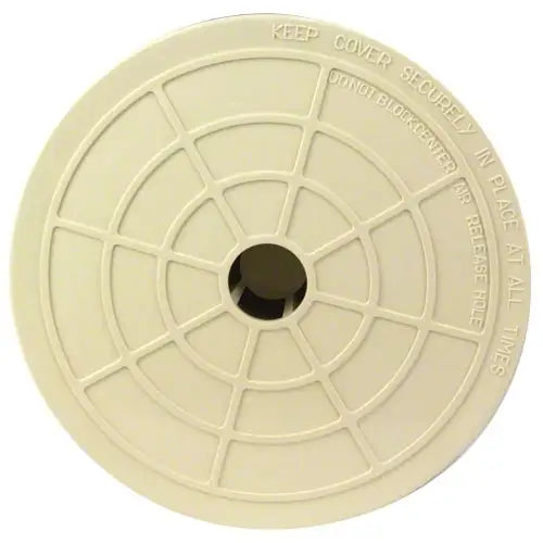 Round beige plastic cover with text on a white background