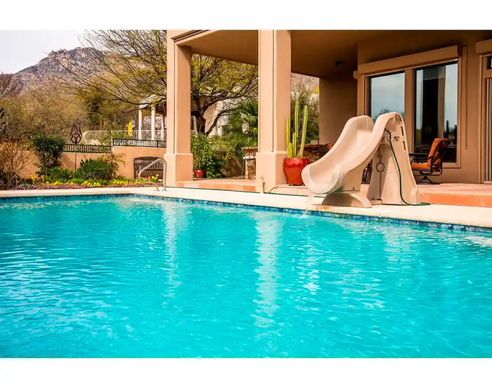 Swimming pool with a slide and mountain view