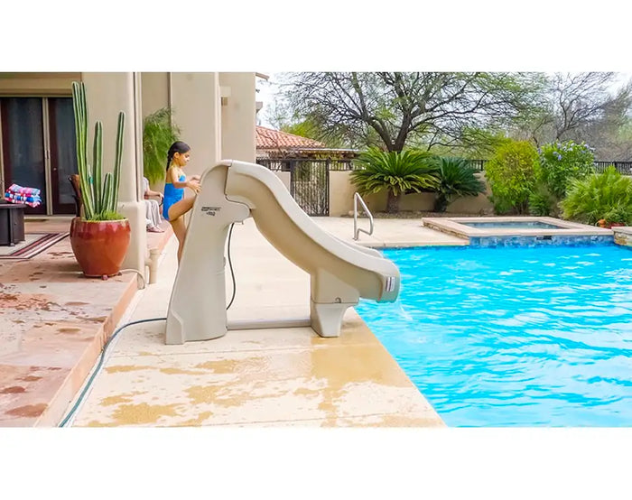 Pool slide next to a swimming pool with a person in the background